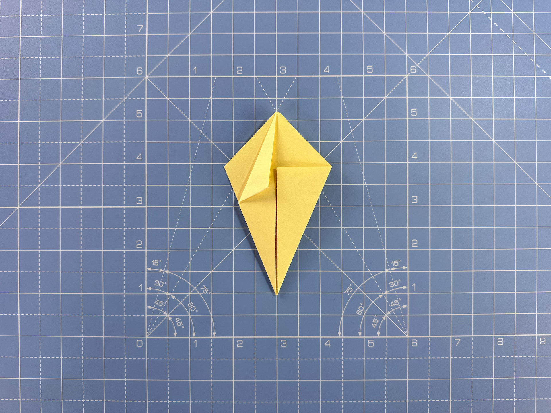 Making an origami flower bud step 17