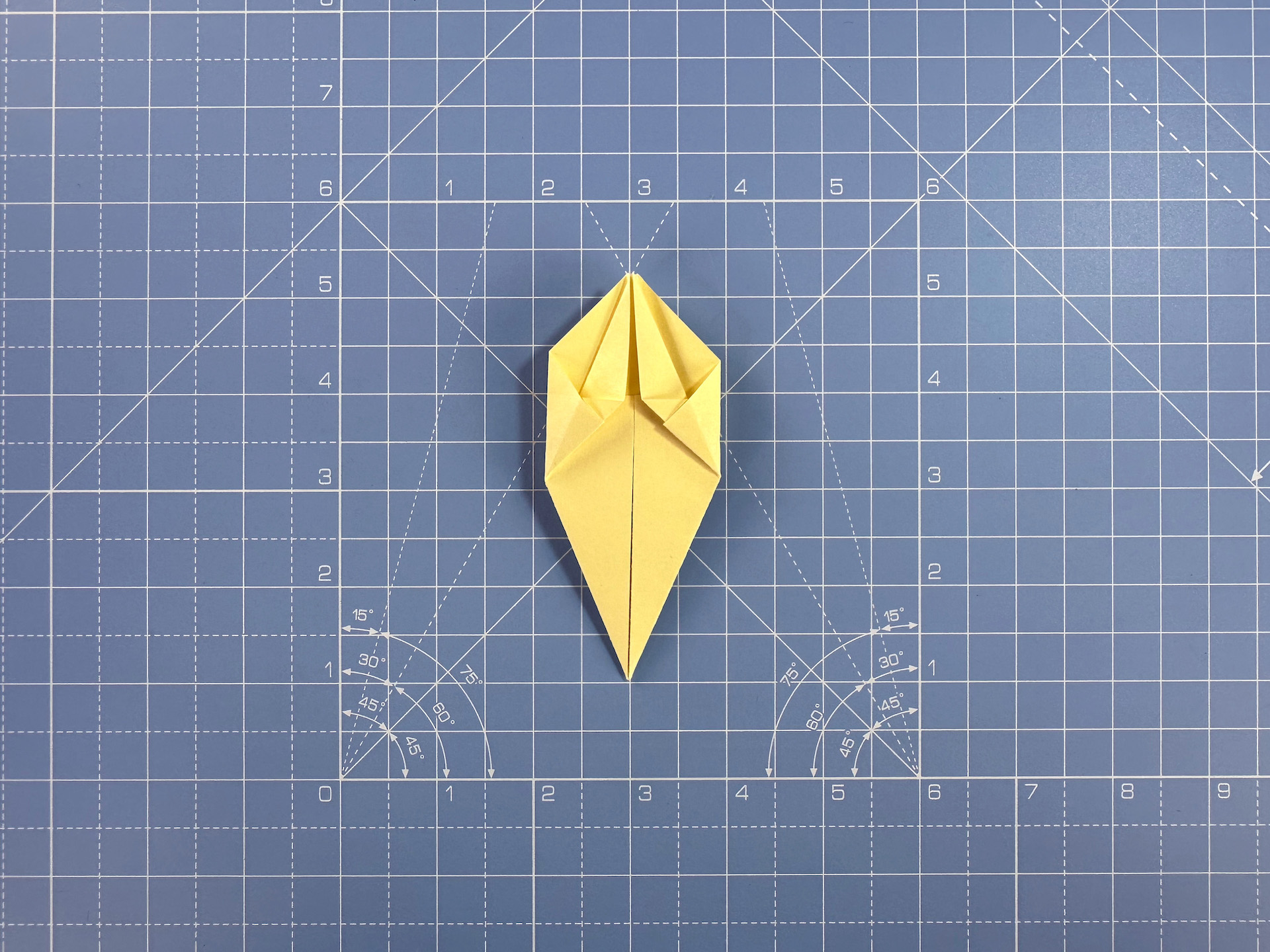 Making an origami flower bud step 19