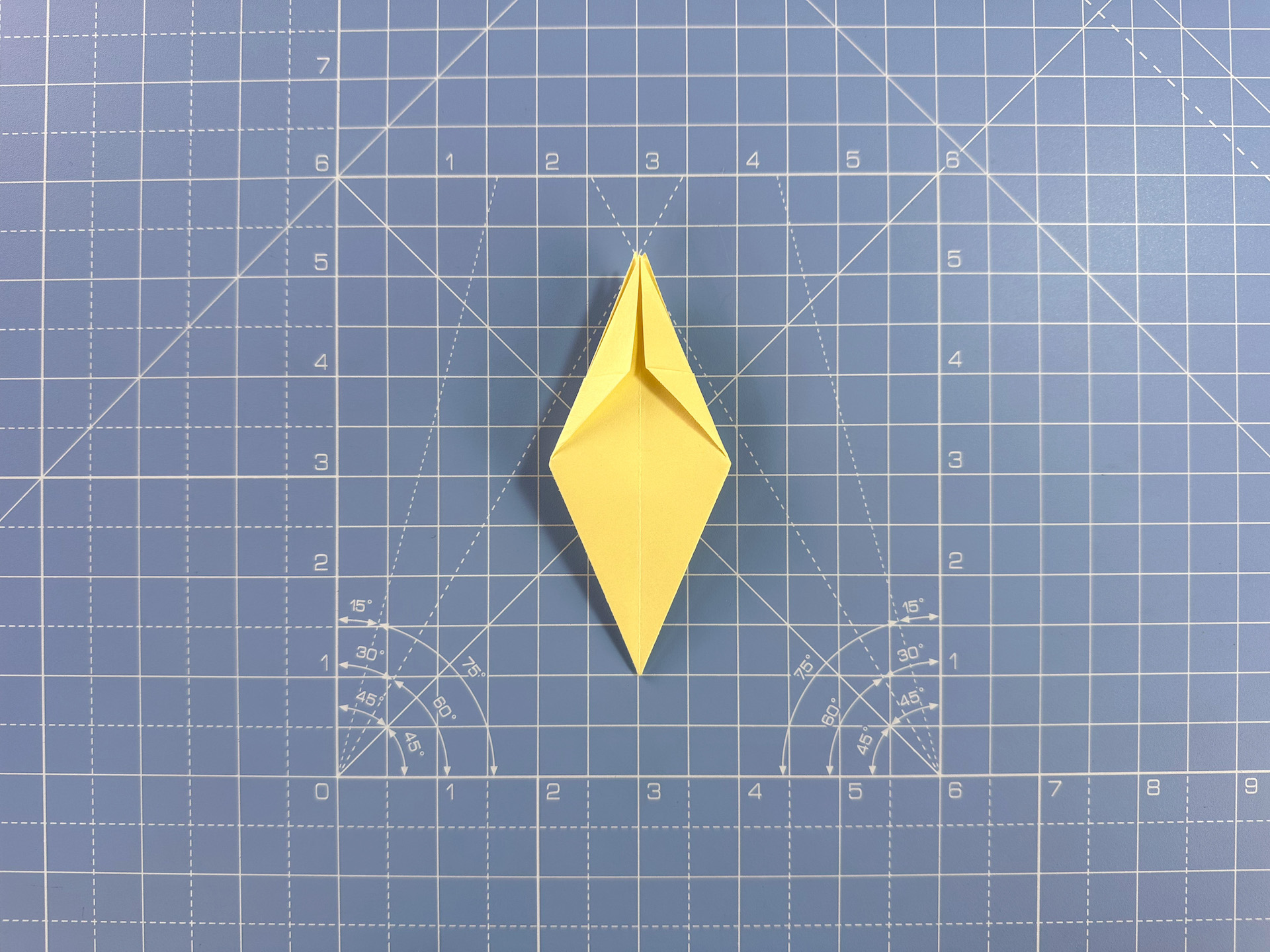 Making an origami flower bud step 21