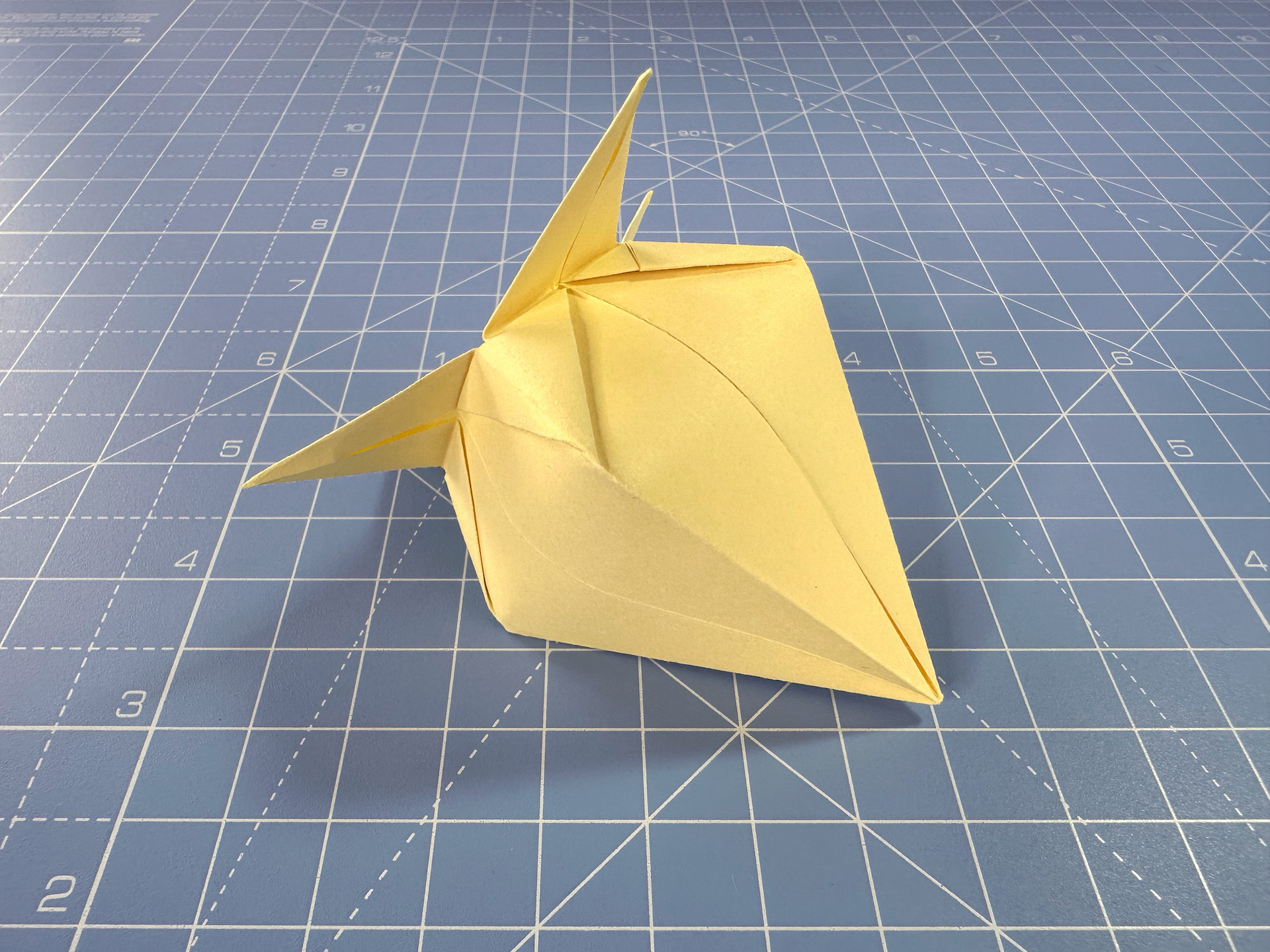 Making an origami flower bud step 22