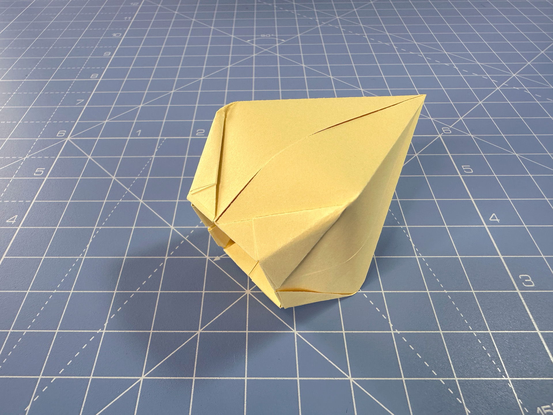 Making an origami flower bud step 23