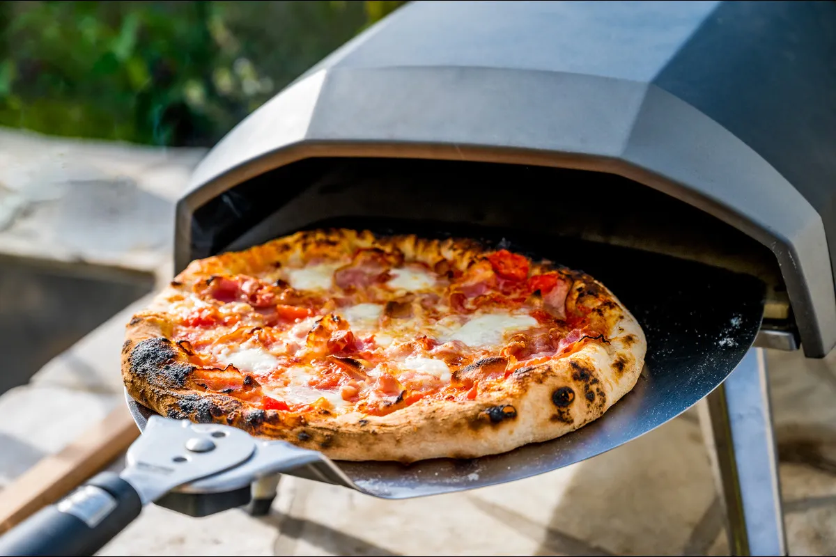 Homemade pizza cooked in a pizza oven in the garden