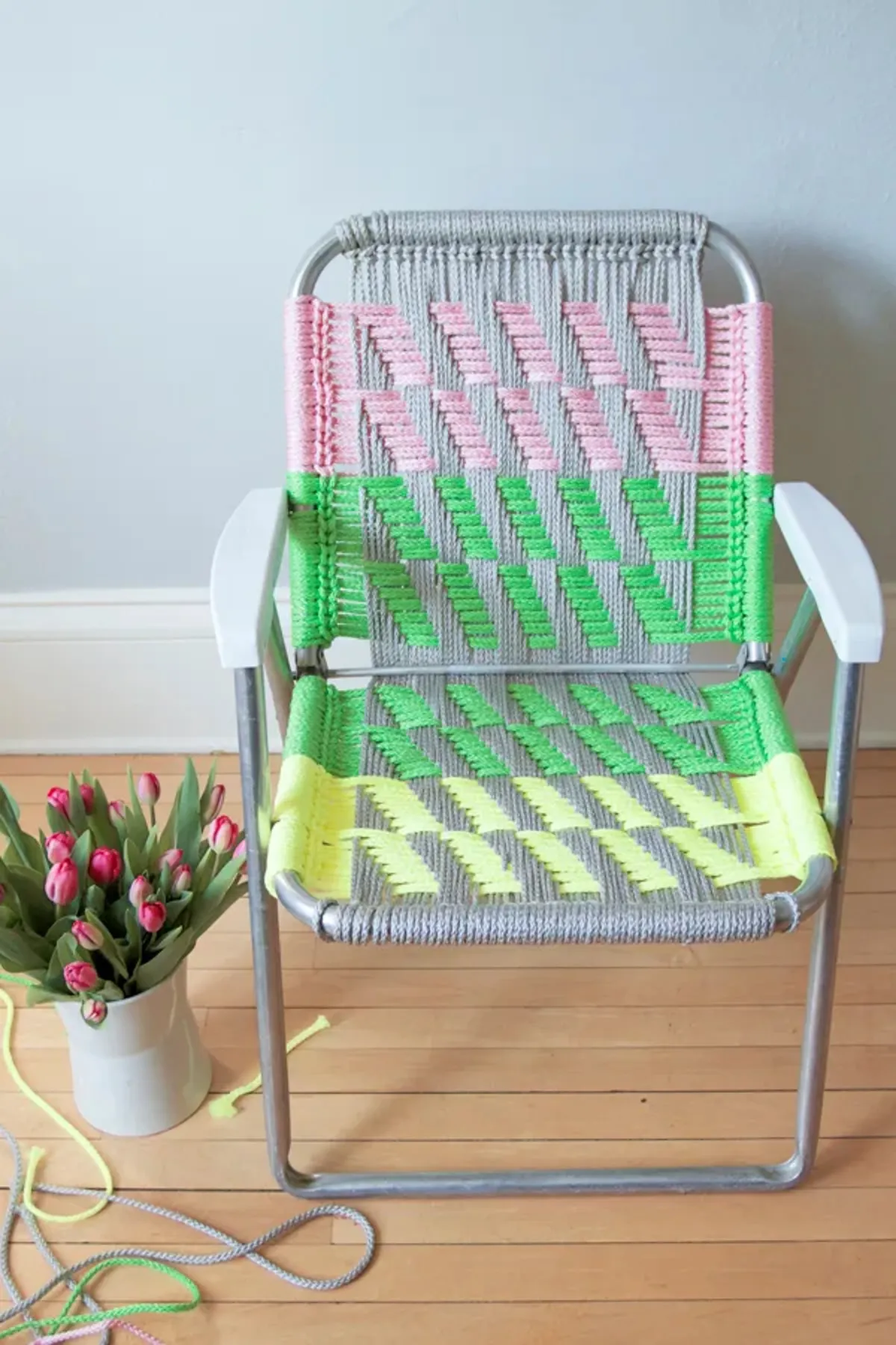Folding metal chair upcycled with colourful macrame in stripes of yellow, green and pink