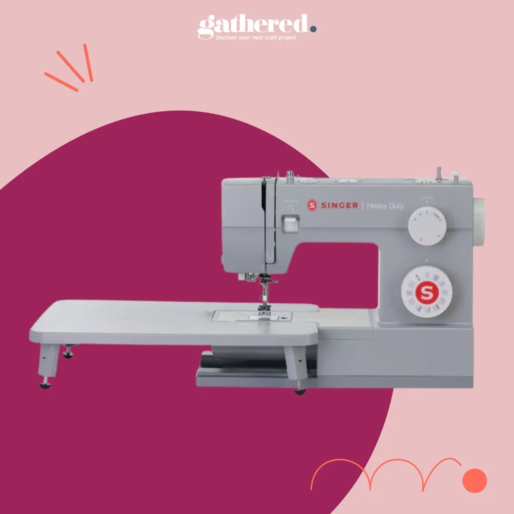 SINGER 6380 Heavy Duty Sewing Machine With Extension Table on a pink background