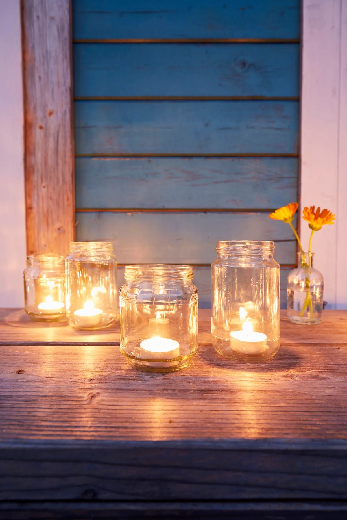 Candles in a glass jar at an outdoor wedding