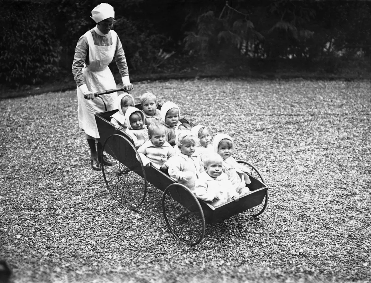 Adoption records. Residents of Dr Barnardo's Babies Castle, in Hawkhurst, Kent, in the 1930s get some fresh air