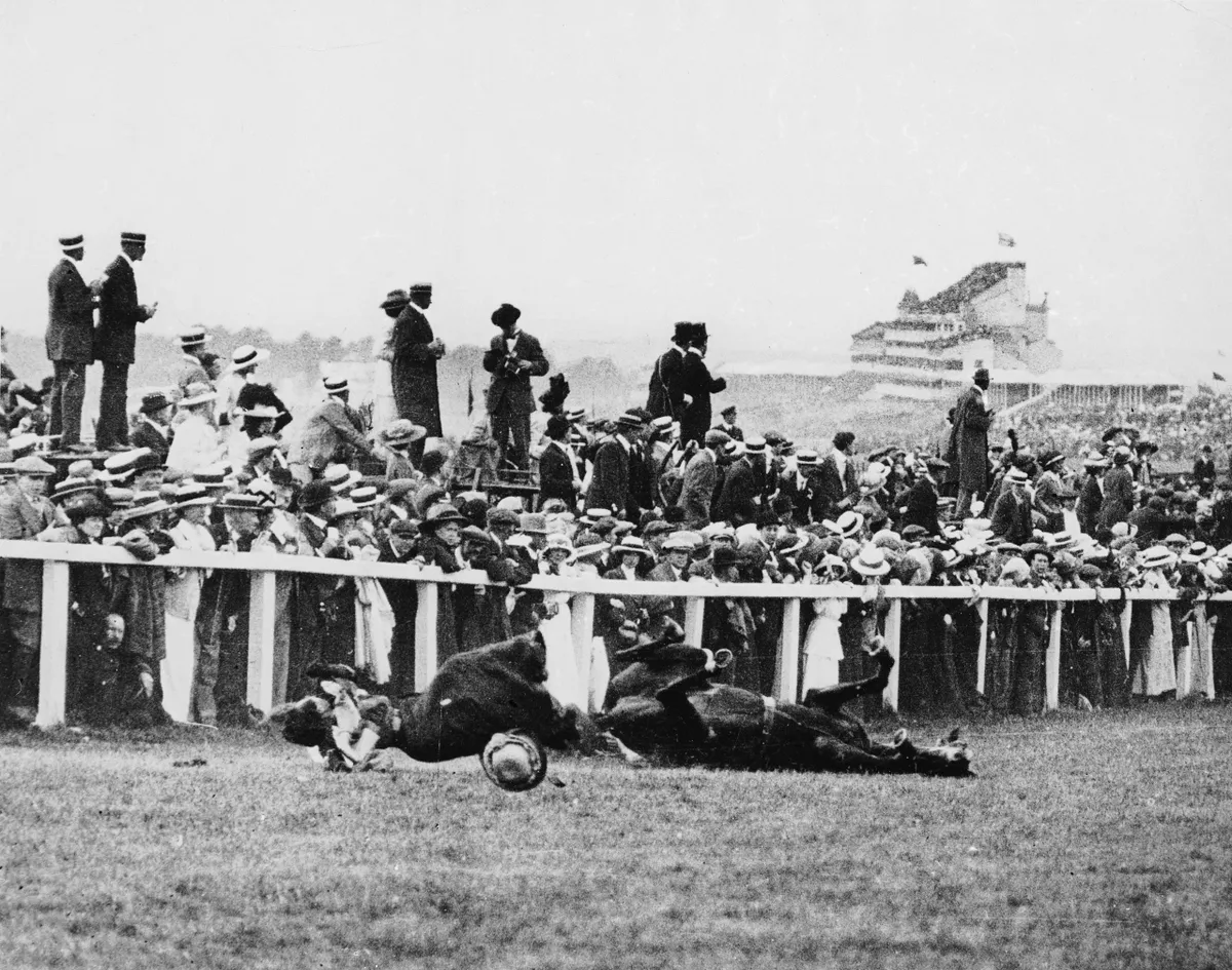 Emily Davison (1872 - 1913) is fatally injured as she tries to stop the King's horse 'Amner' on Derby Day, to draw attention to the Women's Suffragette movement. (Photo by Arthur Barrett/Hulton Archive/Getty Images)