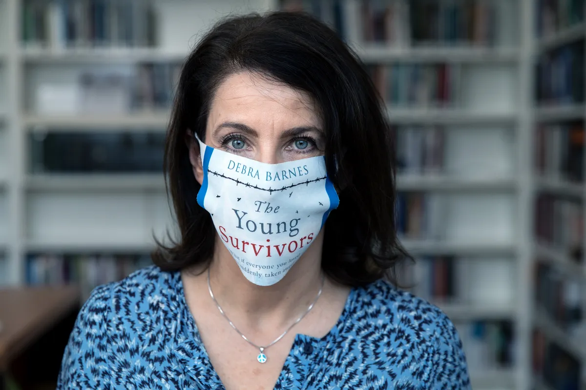 Debra Barnes wearing a face mask promoting The Young Survivors