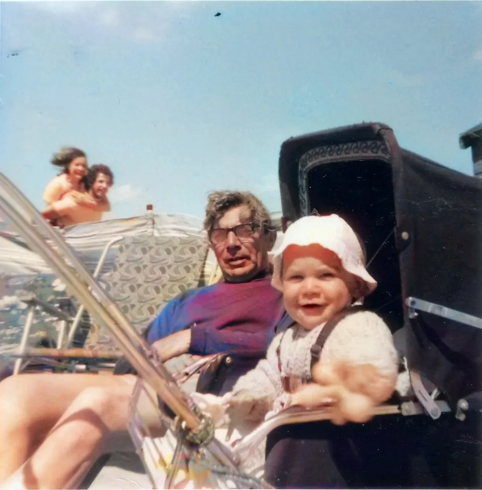 Baby in pram with grandfather in 1973