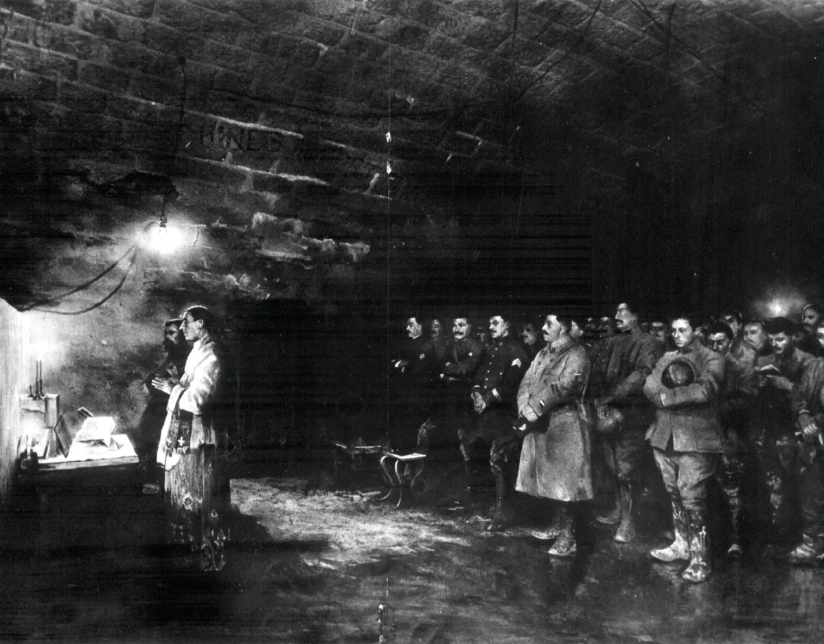 A black and white photograph of a group of men in military uniform attending a church service in a stone building, with a priest standing before an altar illuminated by an overhead lightbulb