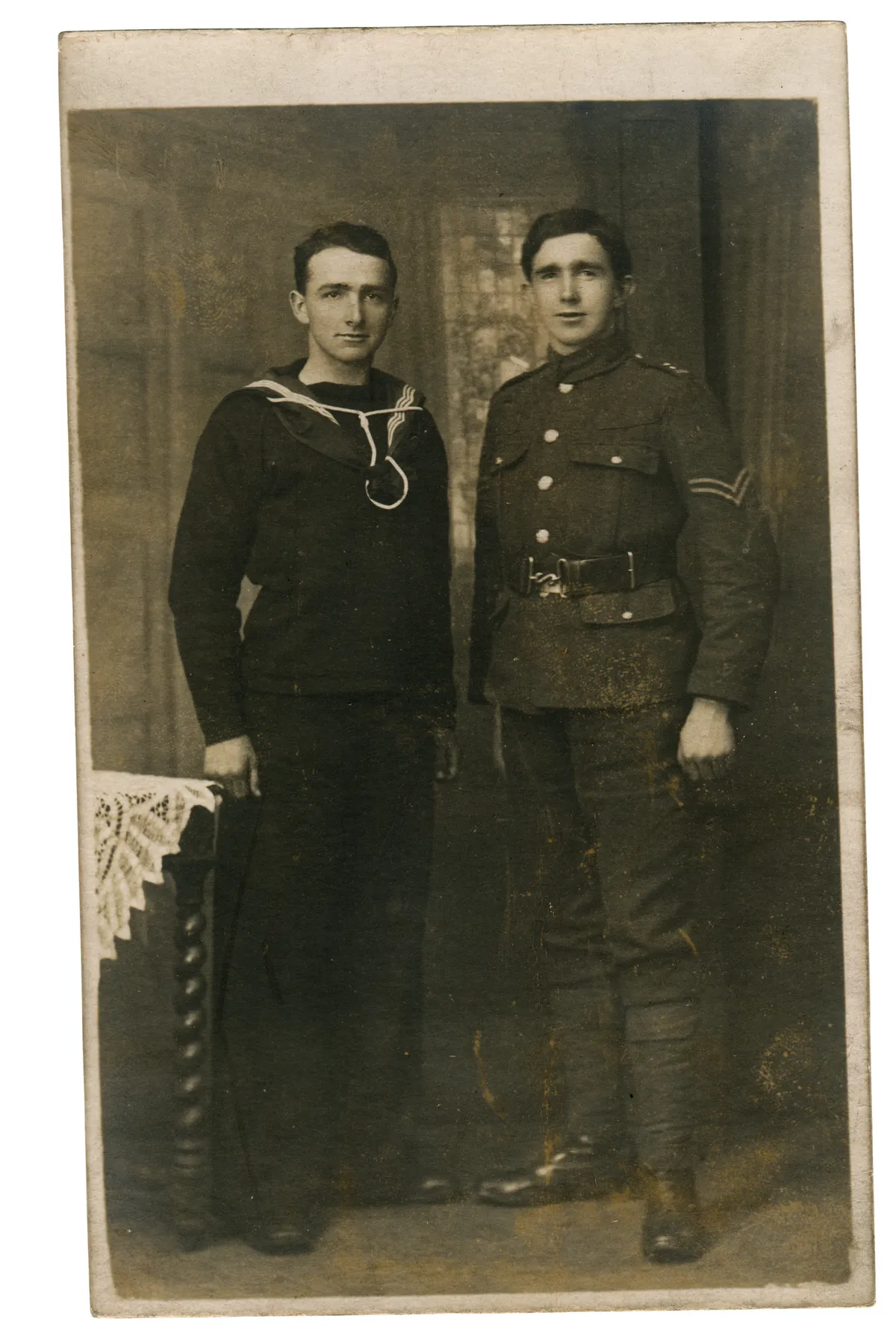 A black and white photograph of two men, one in a naval uniform and one in an army uniform
