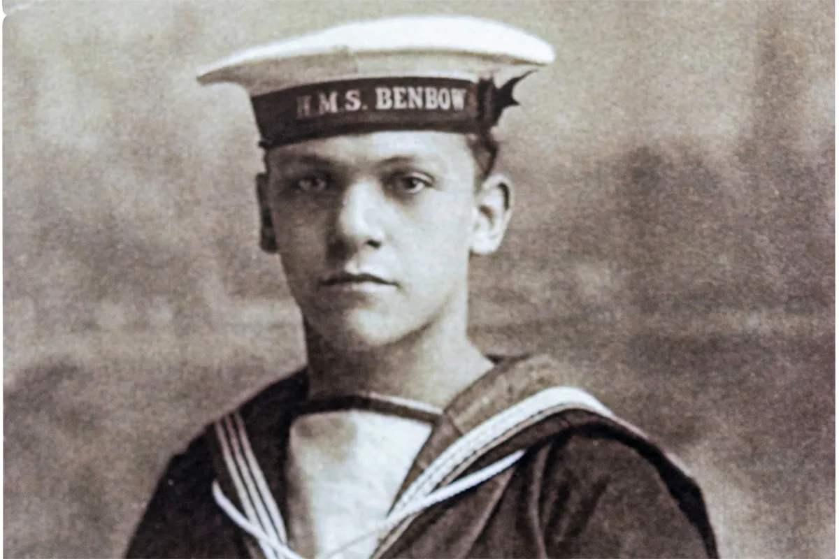 Black and white photograph of a young white man in Royal Navy uniform