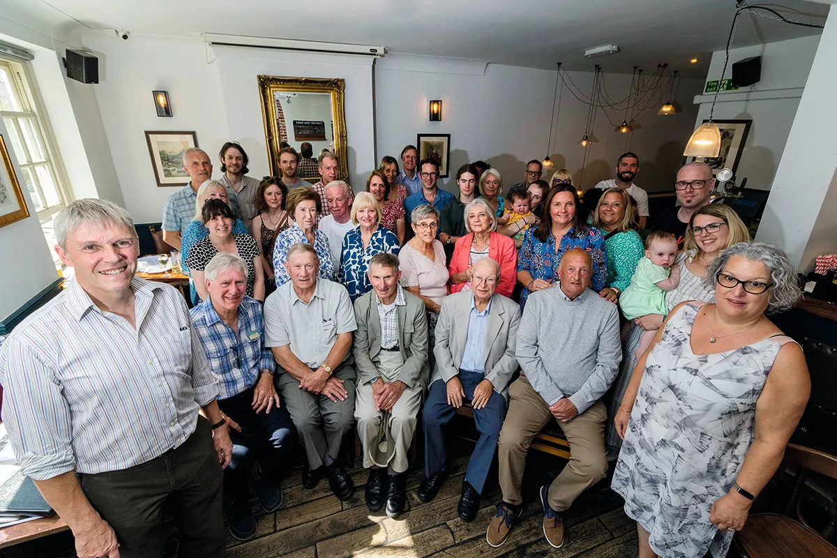 Colour photograph of a large group of people at a reunion in a pub
