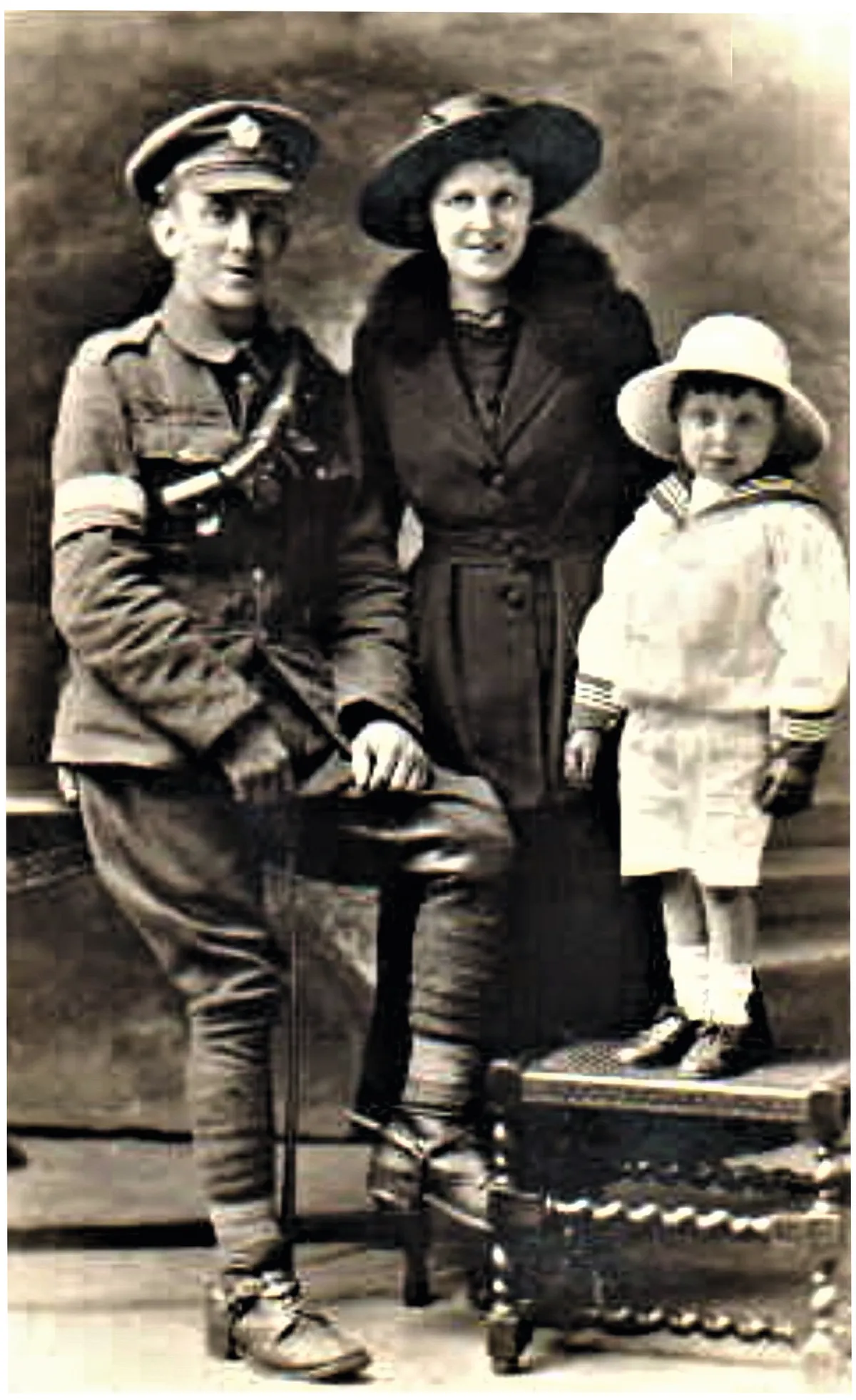 Black and white photograph of a man in First World War army uniform, a woman and a little boy in a sailor suit