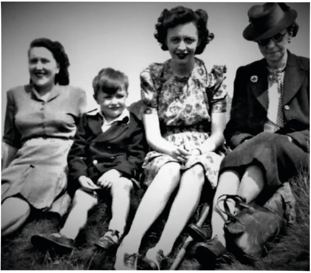 Black and white photograph showing two younger women, a little boy and an older woman sitting in a row