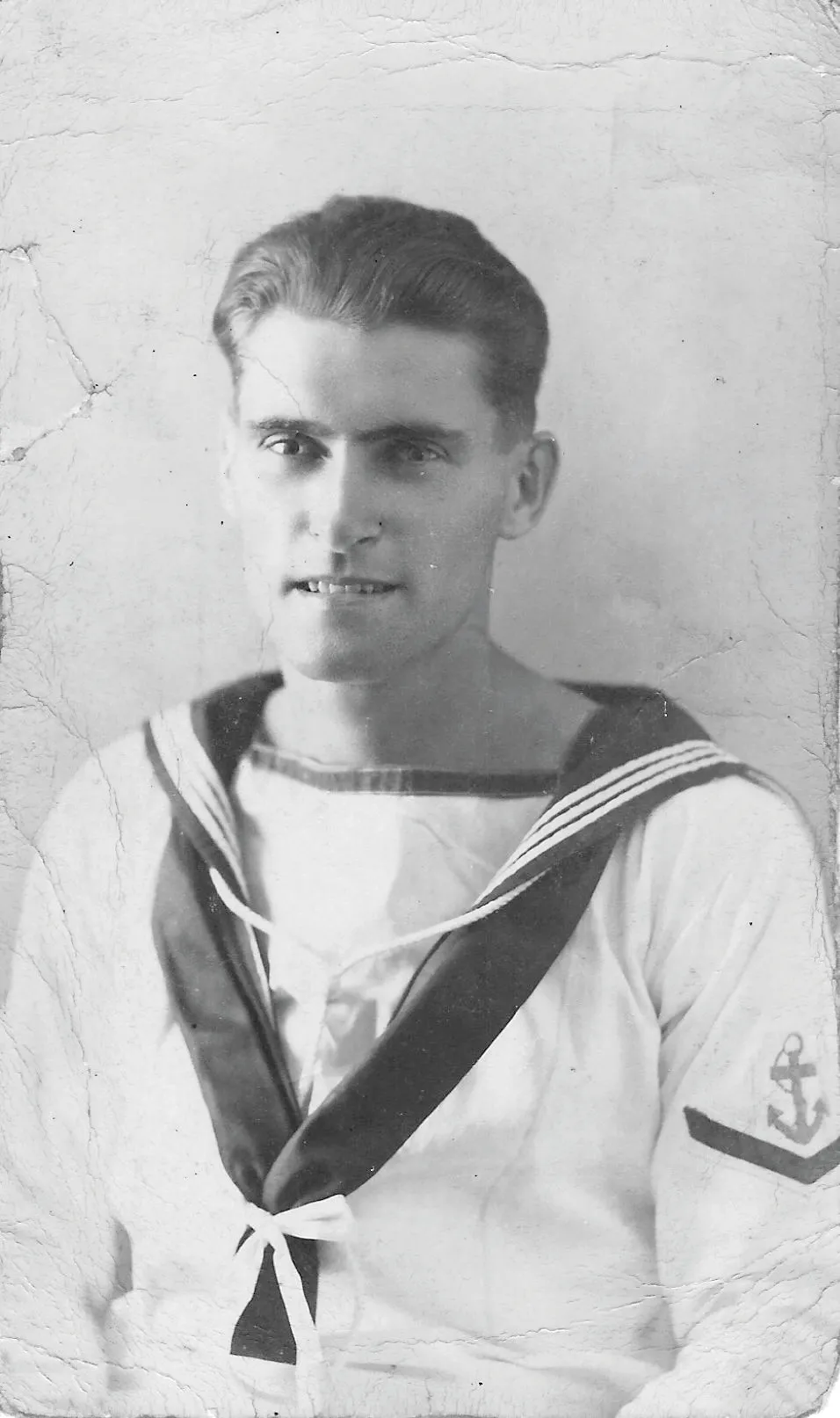 Black and white photograph of a young man in Navy uniform