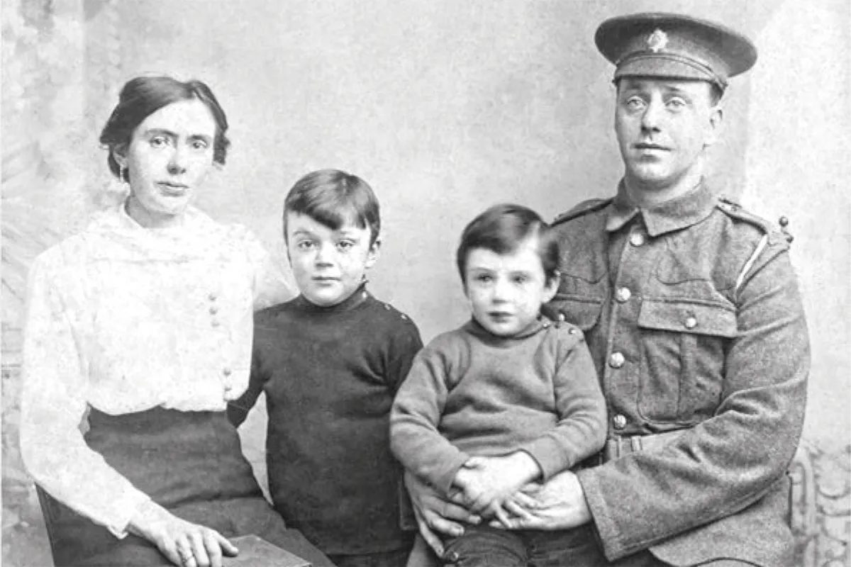 Black and white photograph of a man in First World War uniform with his wife and two little boys