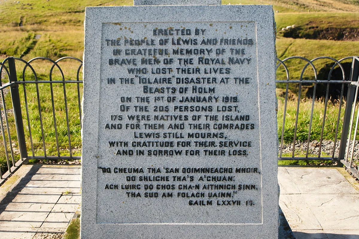 A white memorial stone with an inscription in memory of the Iolaire disaster