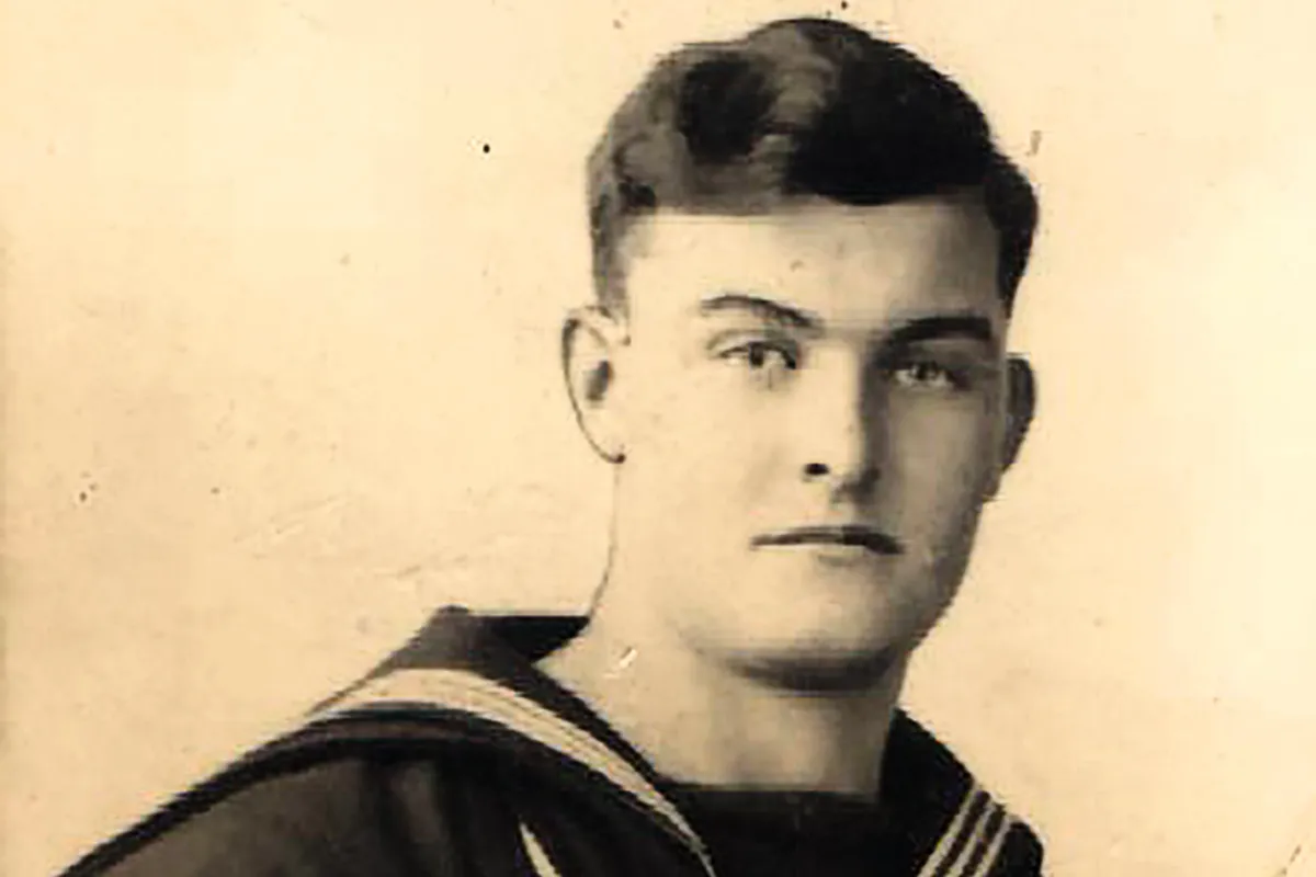 Black and white photograph of a young man wearing a Navy uniform