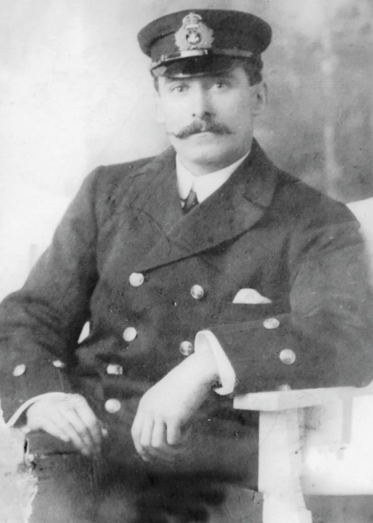 Black and white photograph of a man with a waxed moustache in Navy uniform