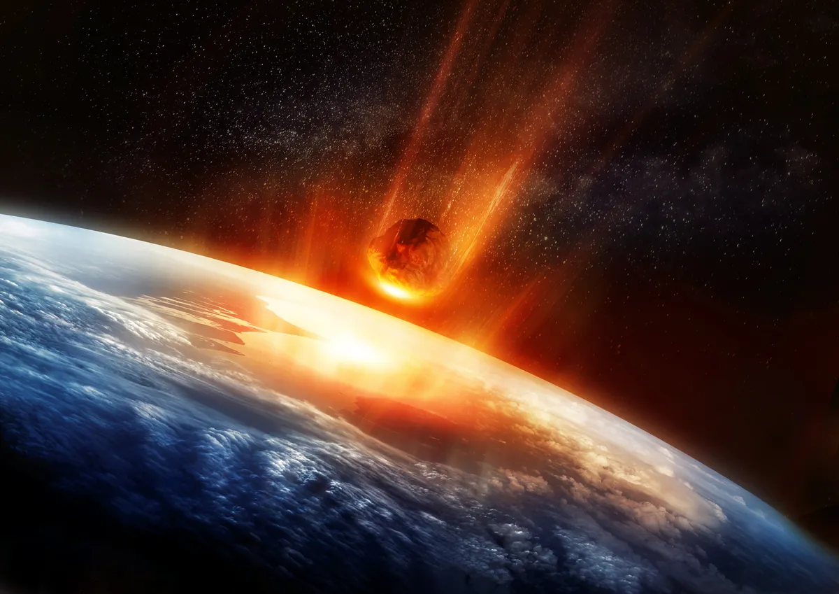 Illustration of a meteor about to strike the earth, as the on 66 million years ago did. solarseven/Getty