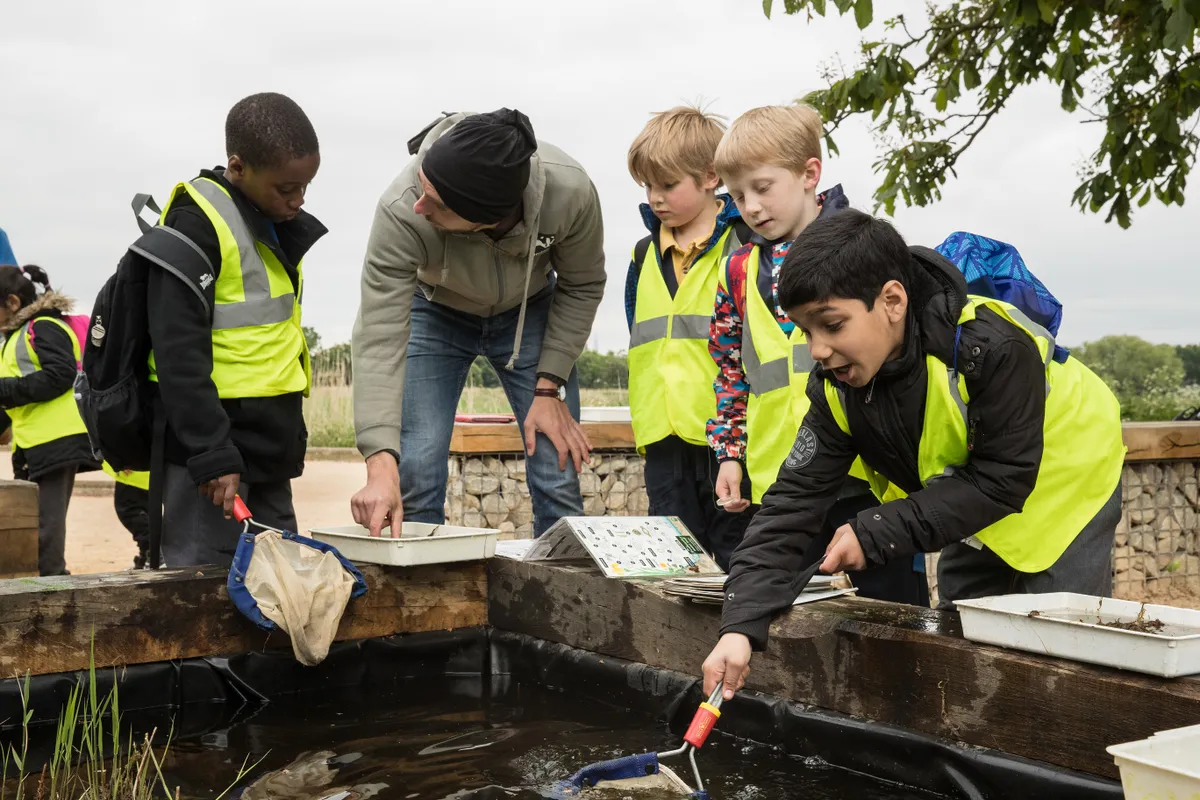 Children pond dipping. Penny Dixie/ The Wildlife Trusts