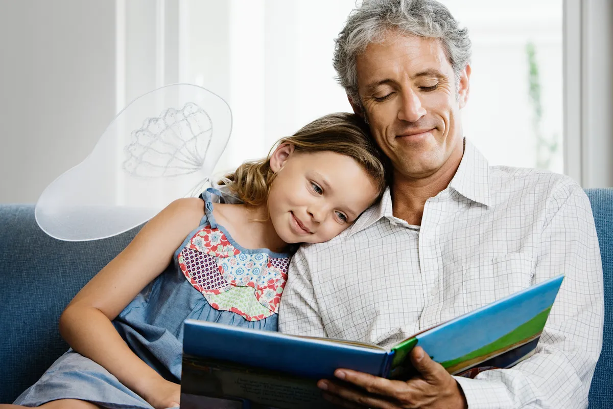 Father reading to daughter.