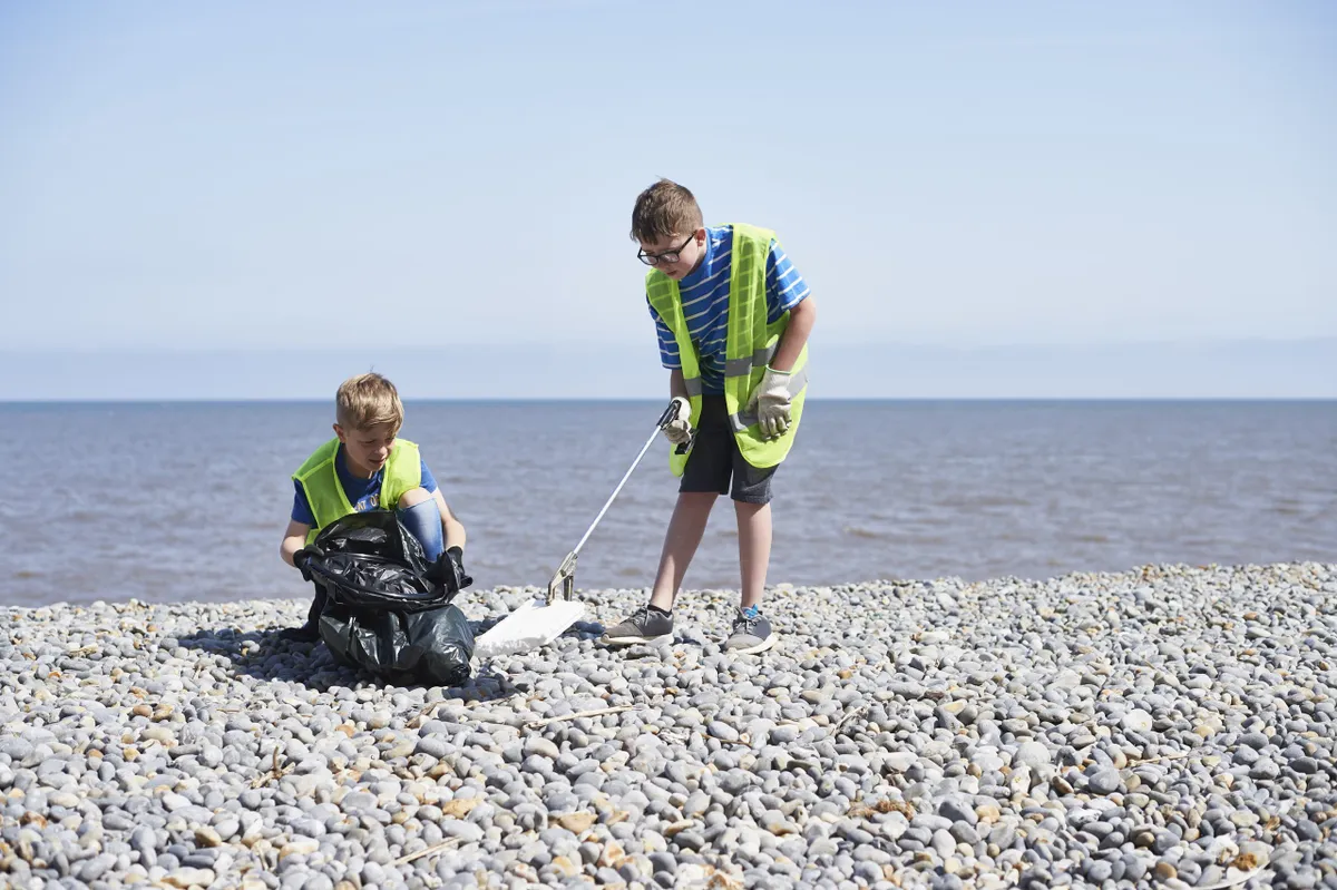 Young volunteers cleaning beach