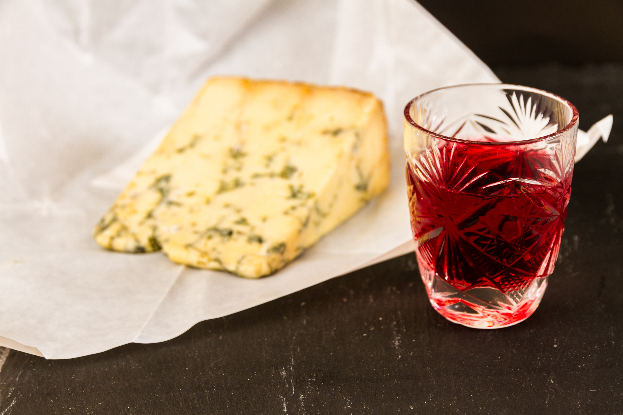 Sloe gin with a wedge of stilton cheese. © Getty