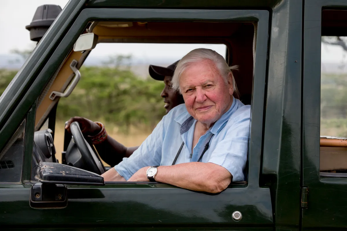 Sir David Attenborough pictured in the Maasai Mara in Kenya while filming David Attenborough: A Life on Our Planet. © Keith Scholey/Silverback Films
