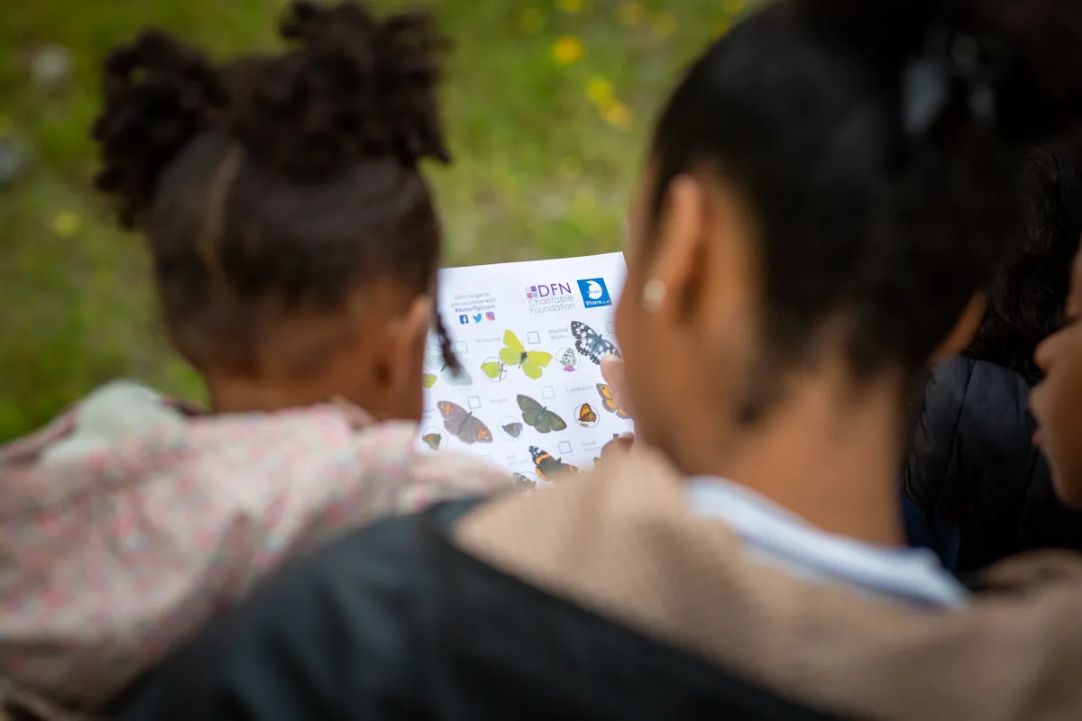 Family using the Big Butterfly Count identification chart. © Butterfly Conservation