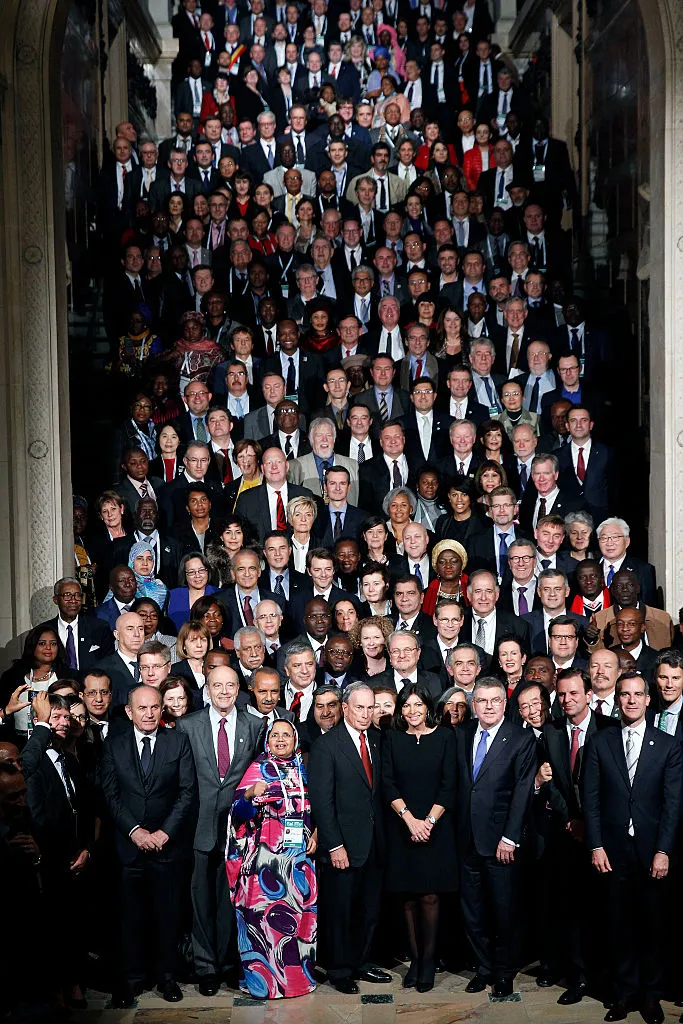 Thousands of male and female mayors from around the world pose vertically along a corridor at the Summit of Mayors at COP201 in Paris 2015