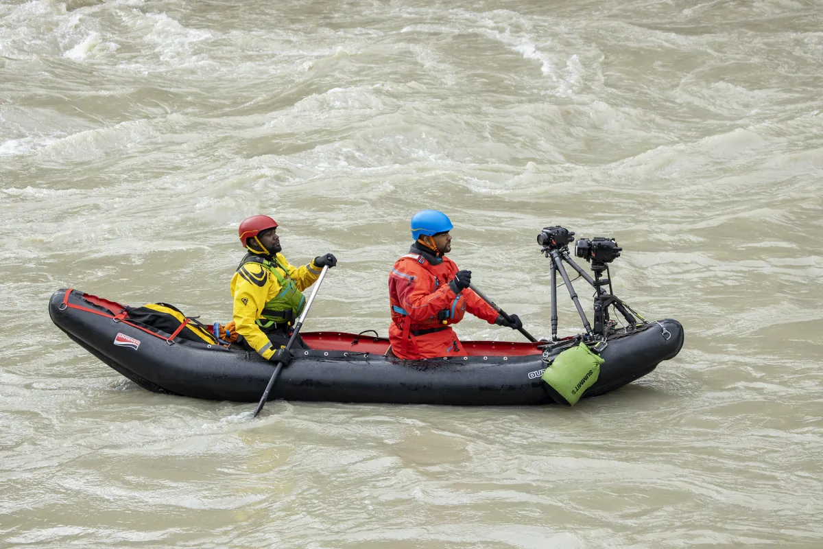 Will Smith (at the front) and Dwayne Fields in a black kayak (which has small cameras mounted on the front of it, facing back at them)