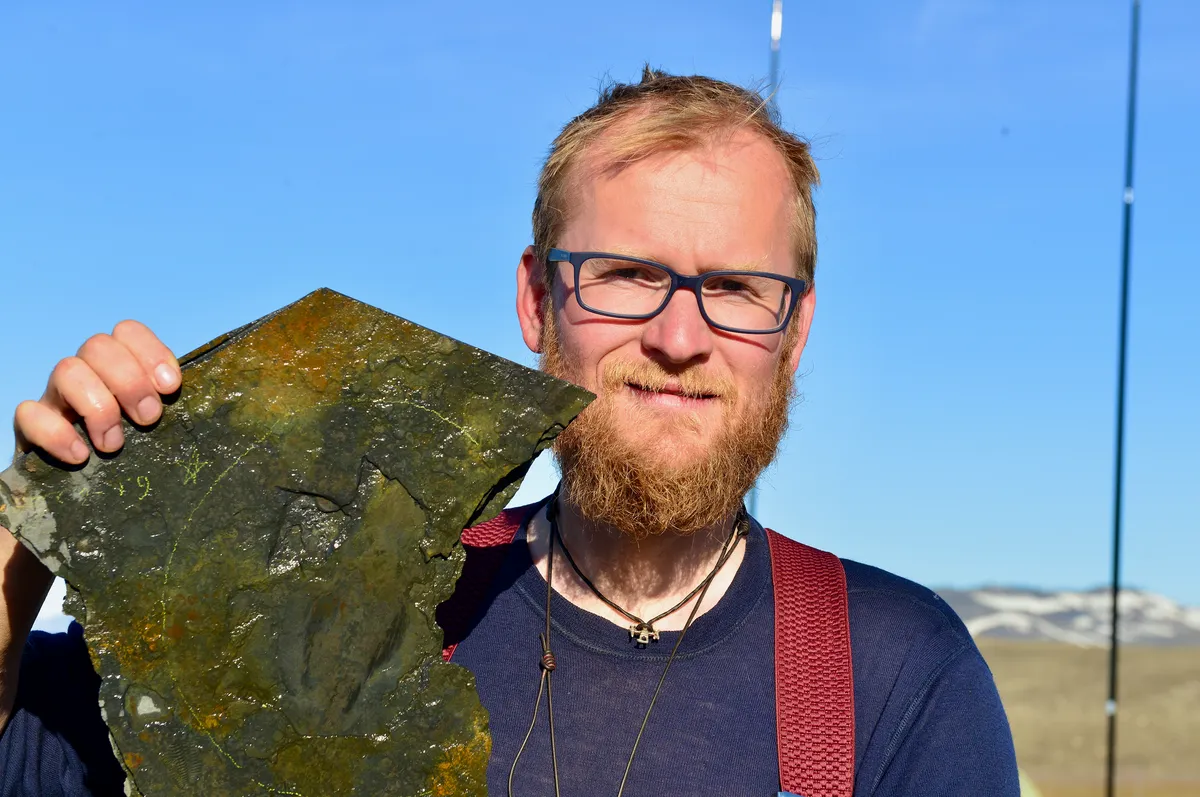 Jakob Vinther at the Sirius Passet locality in 2017 showing the largest specimen of Timorebestia after it was found