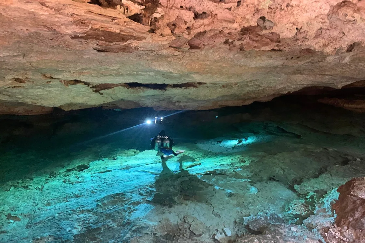 “Once they descend into the cave, they trudge 150m in the pitch black ...