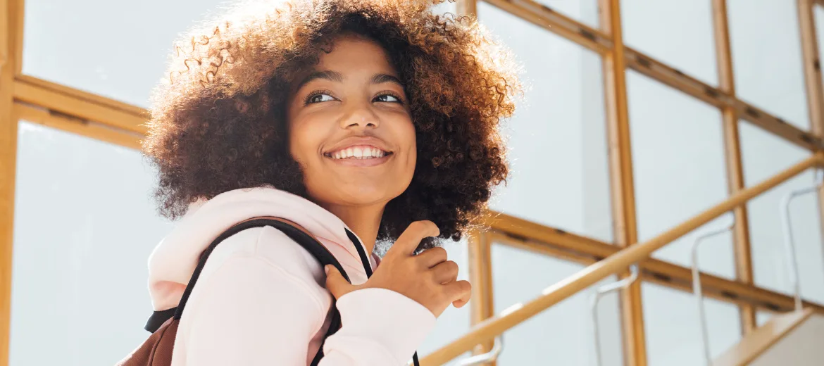 23-08-selektion-minder-schweizer-elternmagazin-hg Selektion: Teenager of color steigt lächelnd die Schultreppe hoch