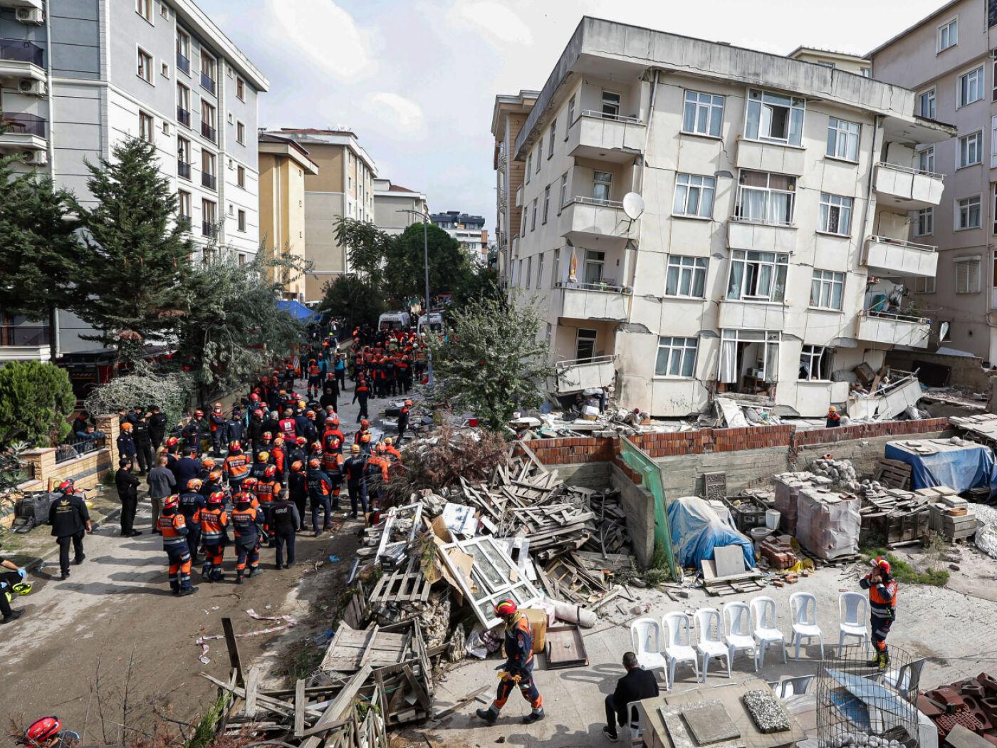 Feuerwehrleute und Rettungskräfte sind an einem eingestürzten mehrstöckigen Gebäude im Einsatz. Foto: Abdullah Tepeli/Dia Photo/AP/dpa