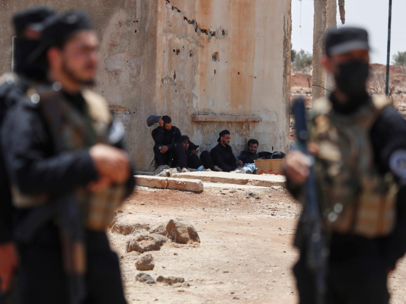 ARCHIV - Syrische Sicherheitskräfte ruhen sich in der Nähe eines beschädigten Gebäudes aus, während sie im Dorf Busra al-Harir im Süden Syriens eingesetzt werden. Foto: Omar Sanadiki/AP/dpa