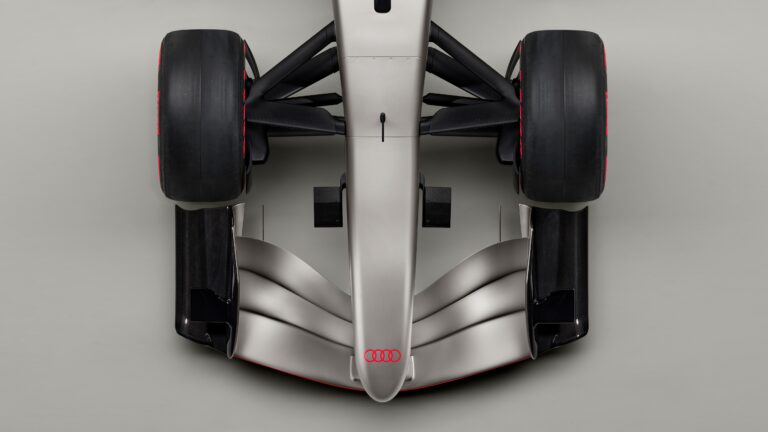 Indoor studio shot, exterior, birds-eye view, detail of wheel suspension, nose, and front wing